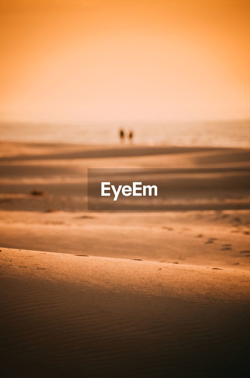 SCENIC VIEW OF BEACH AGAINST SKY DURING SUNSET