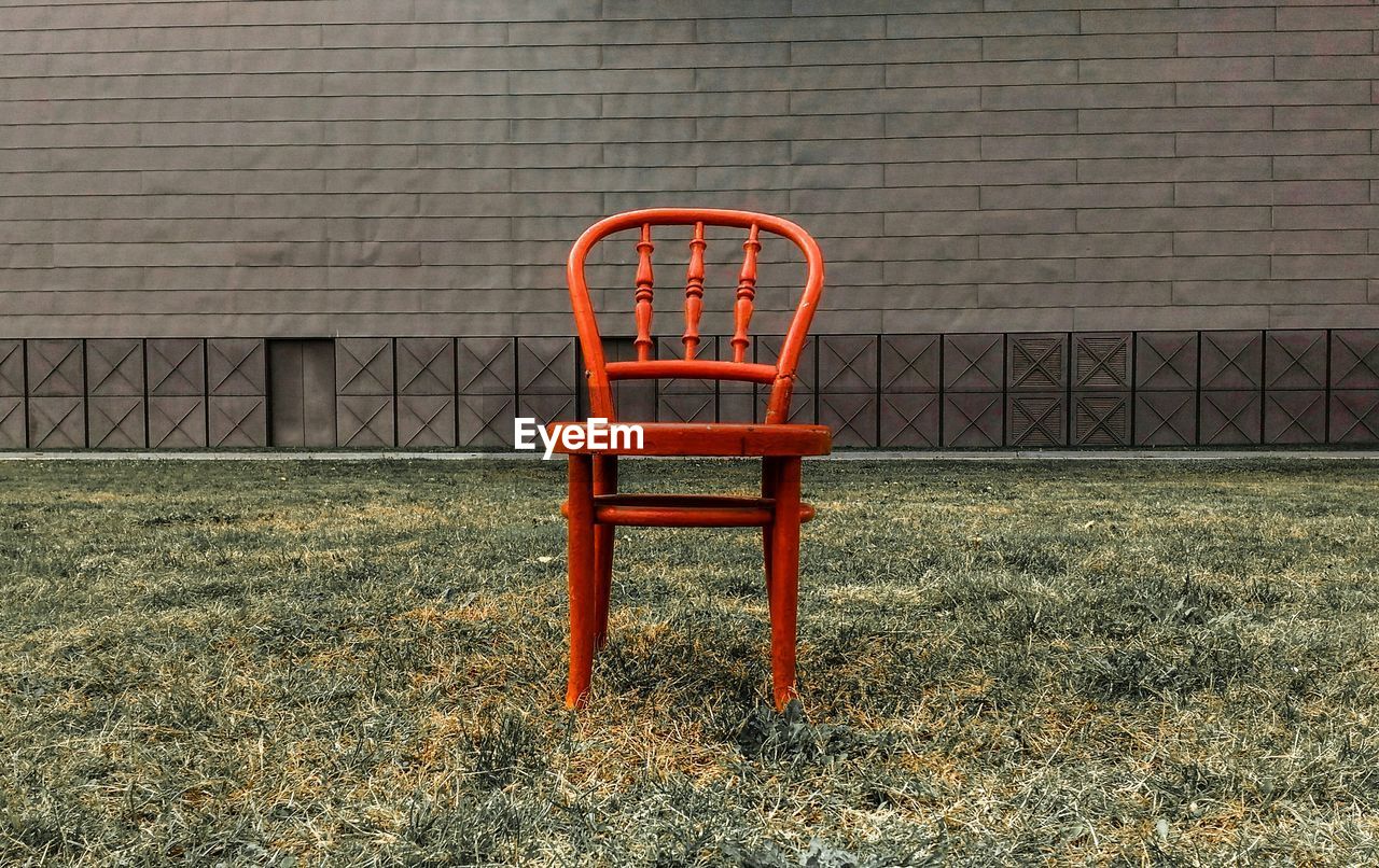 CHAIR ON GRASS AGAINST BUILDING