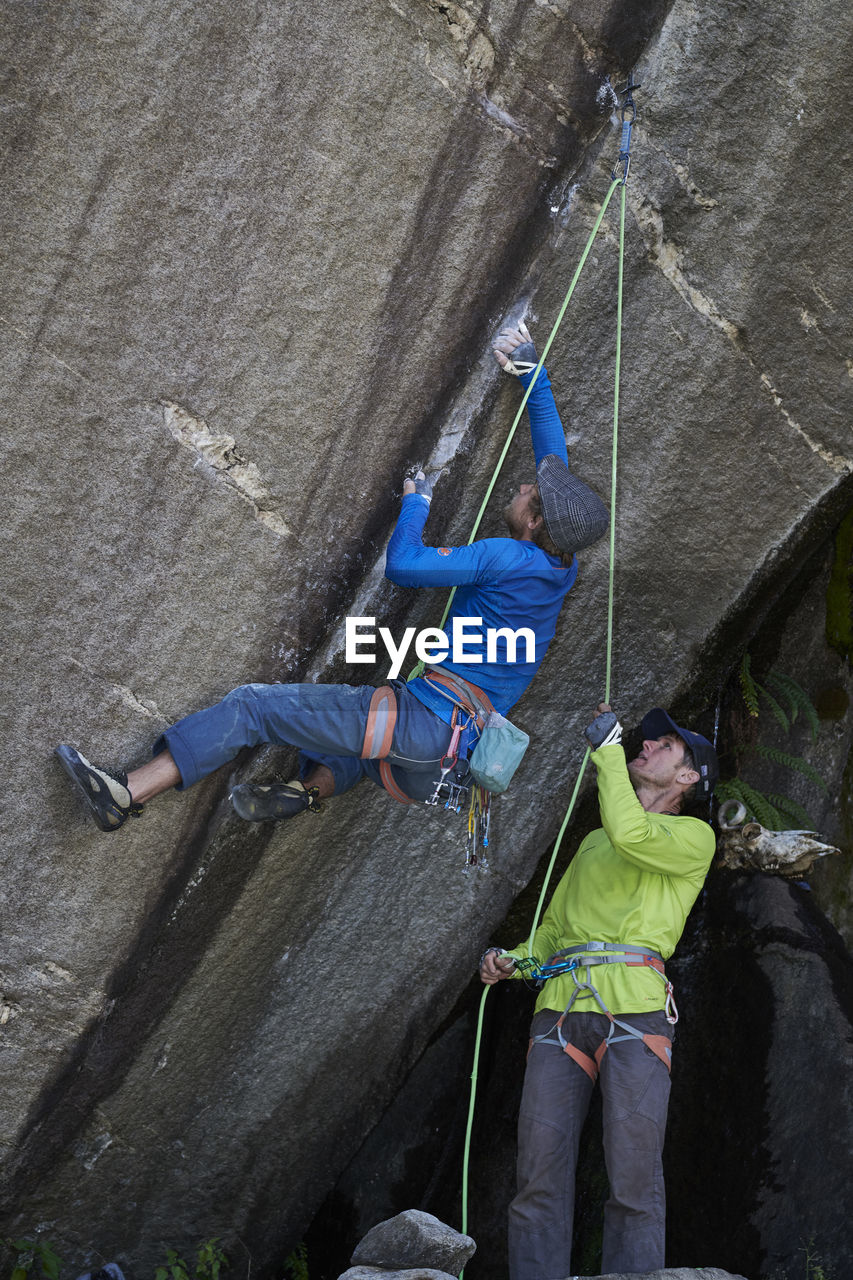 HIGH ANGLE VIEW OF PEOPLE ON ROCKS