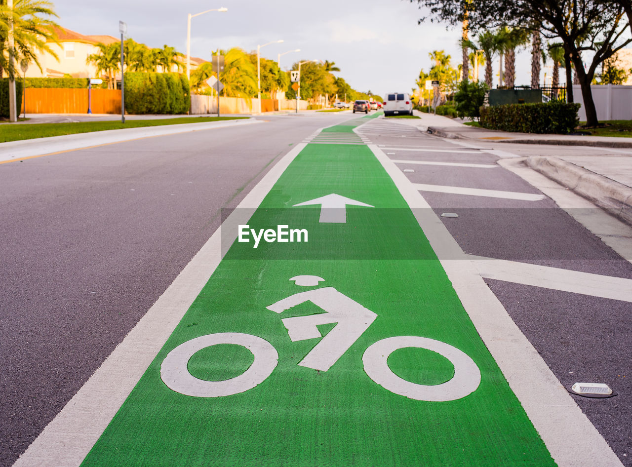 Close-up of bicycle lane sign on road in city