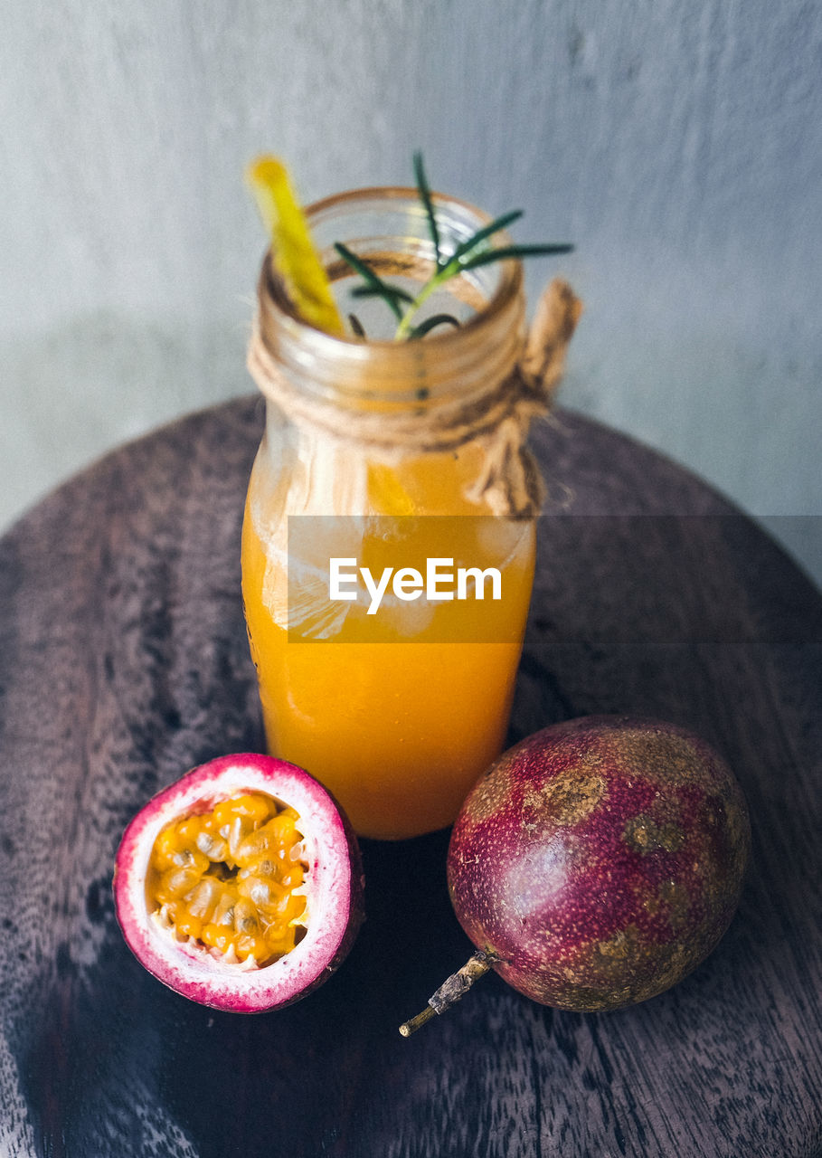 CLOSE-UP OF FRUITS WITH DRINK ON TABLE