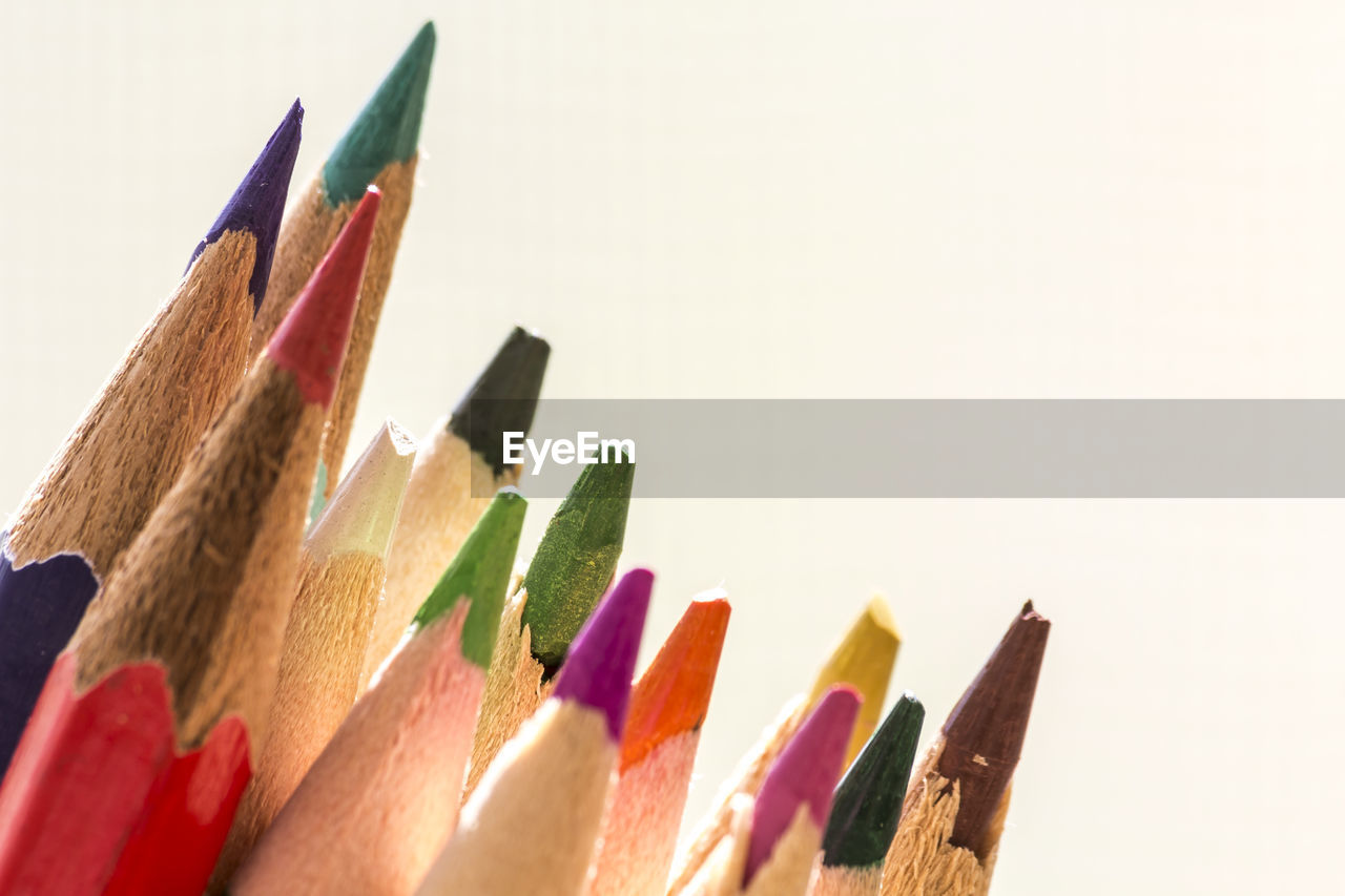 Close-up of colored pencils against white background