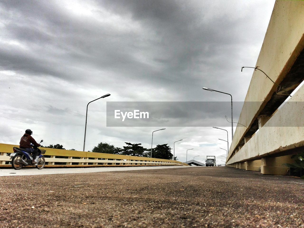 ROAD AGAINST CLOUDY SKY