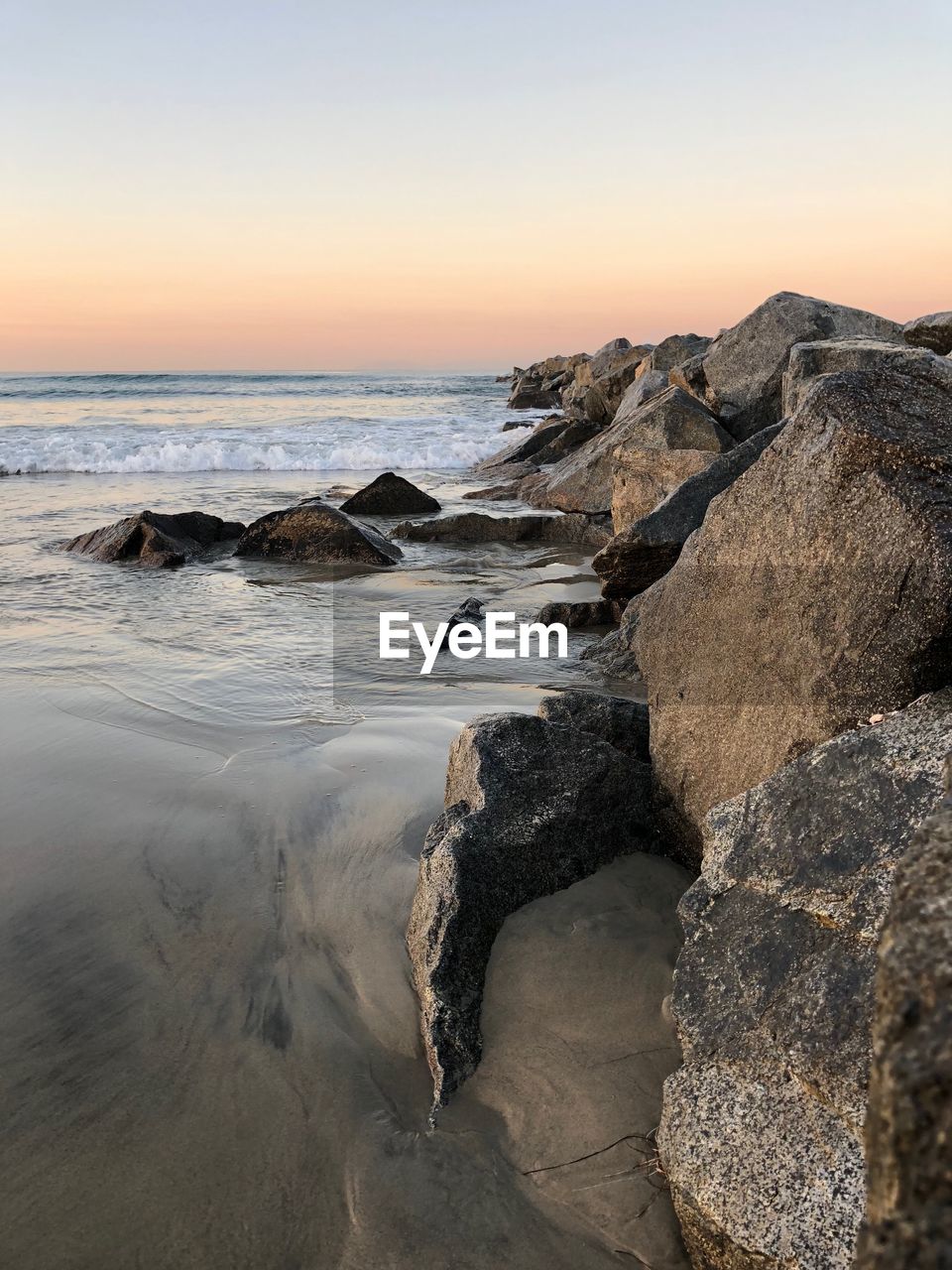 Scenic view of sea against clear sky at sunset