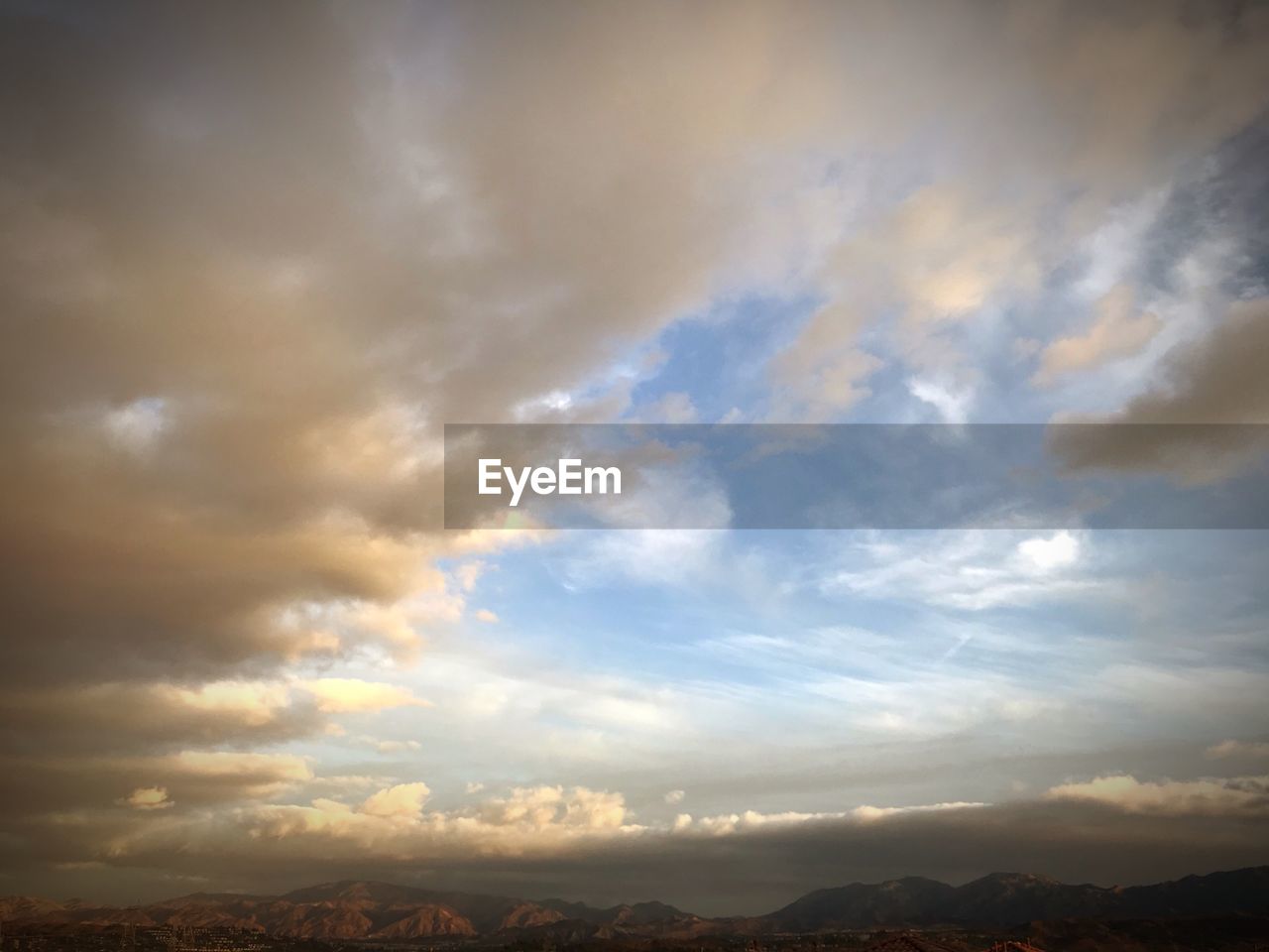 SCENIC VIEW OF SKY AND MOUNTAINS AGAINST SUNSET