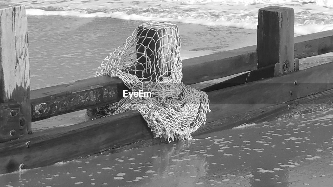 Fishing net on wooden post at beach