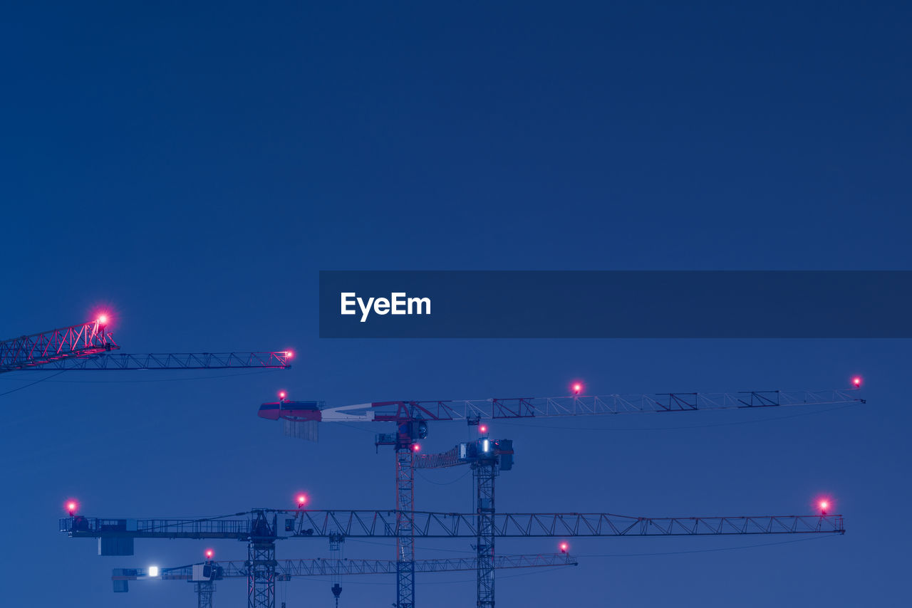 ILLUMINATED LIGHTS AGAINST CLEAR BLUE SKY AT NIGHT
