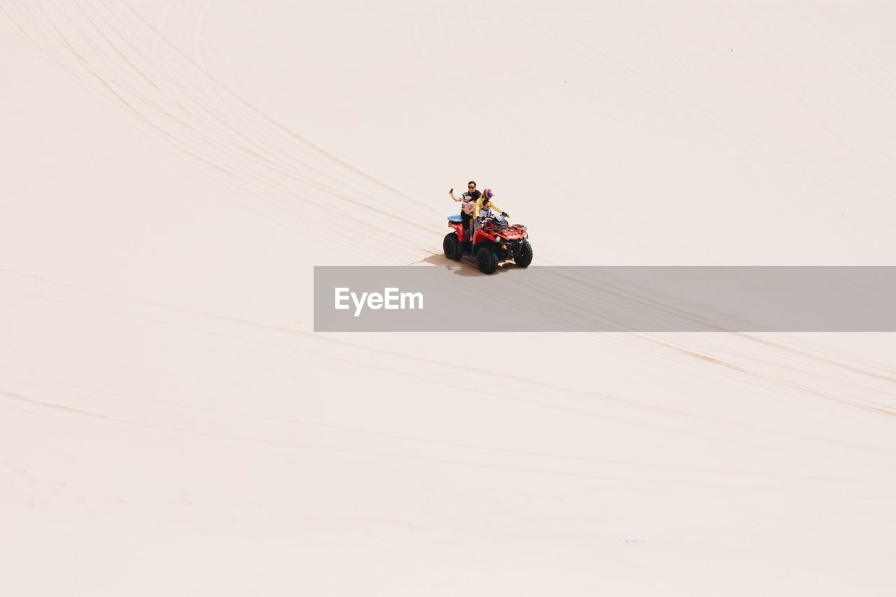 High angle view of family on quadbike at desert