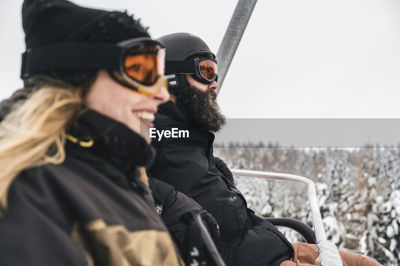 Italy, modena, cimone, couple in a ski lift