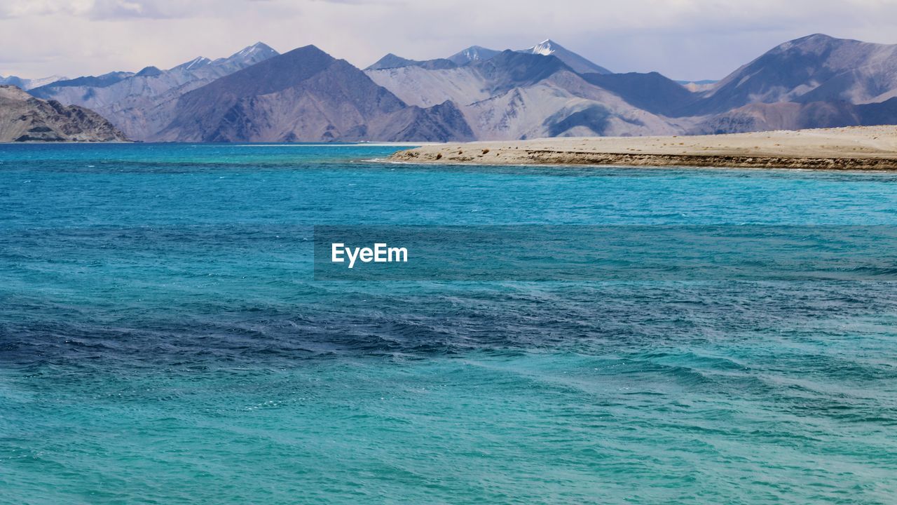 Scenic view of sea with mountains in background