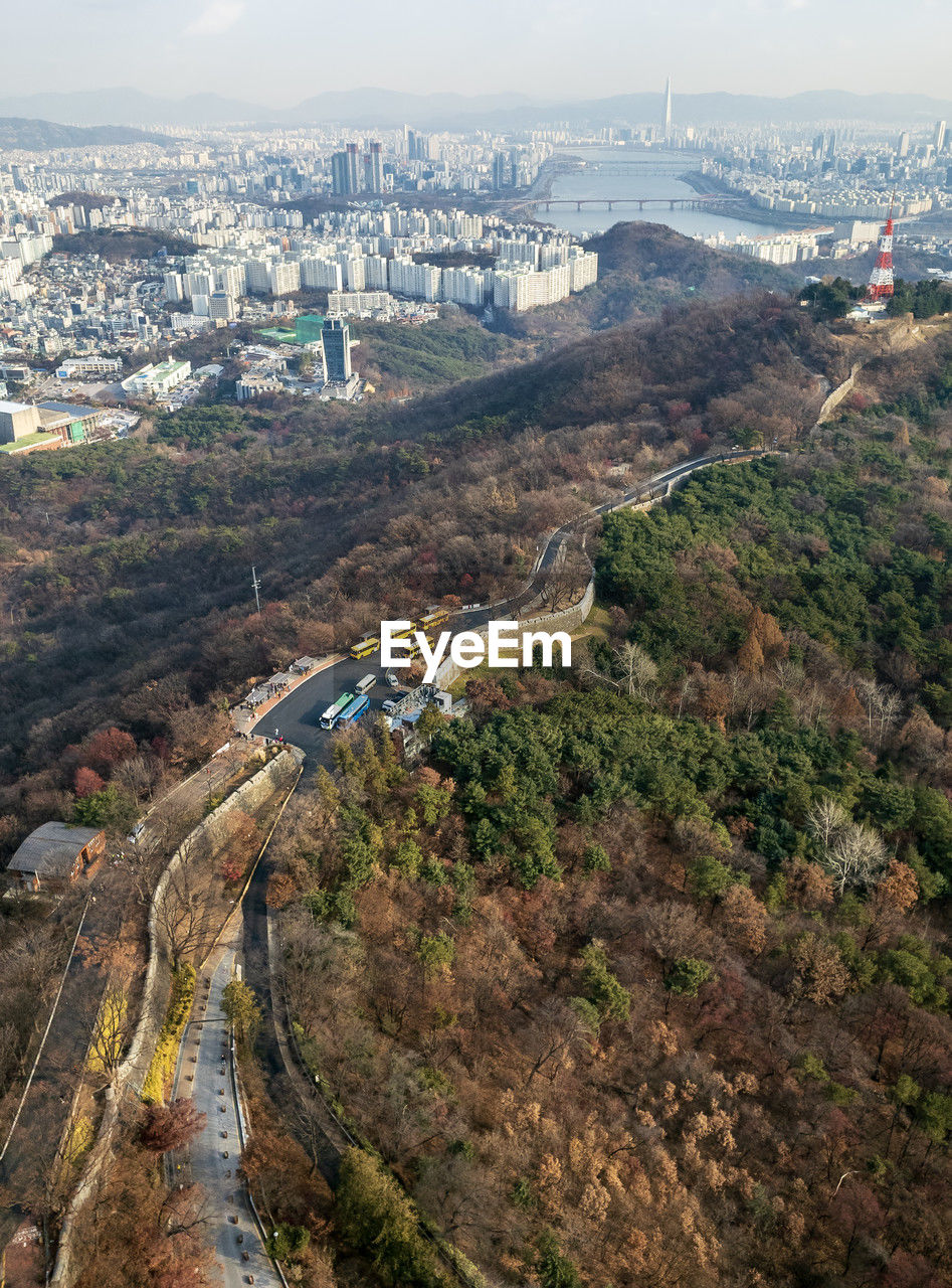 aerial photography, architecture, built structure, city, building exterior, high angle view, cityscape, nature, building, transportation, travel destinations, landscape, road, sky, aerial view, environment, travel, no people, coast, day, outdoors, hill, cloud, tourism, scenics - nature, landmark, land, residential district, plant, tree, water, river, bird's-eye view, street