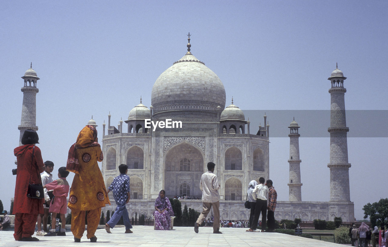 rear view of people in front of church against clear sky