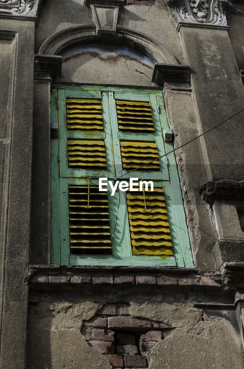 Low angle view of window on old building