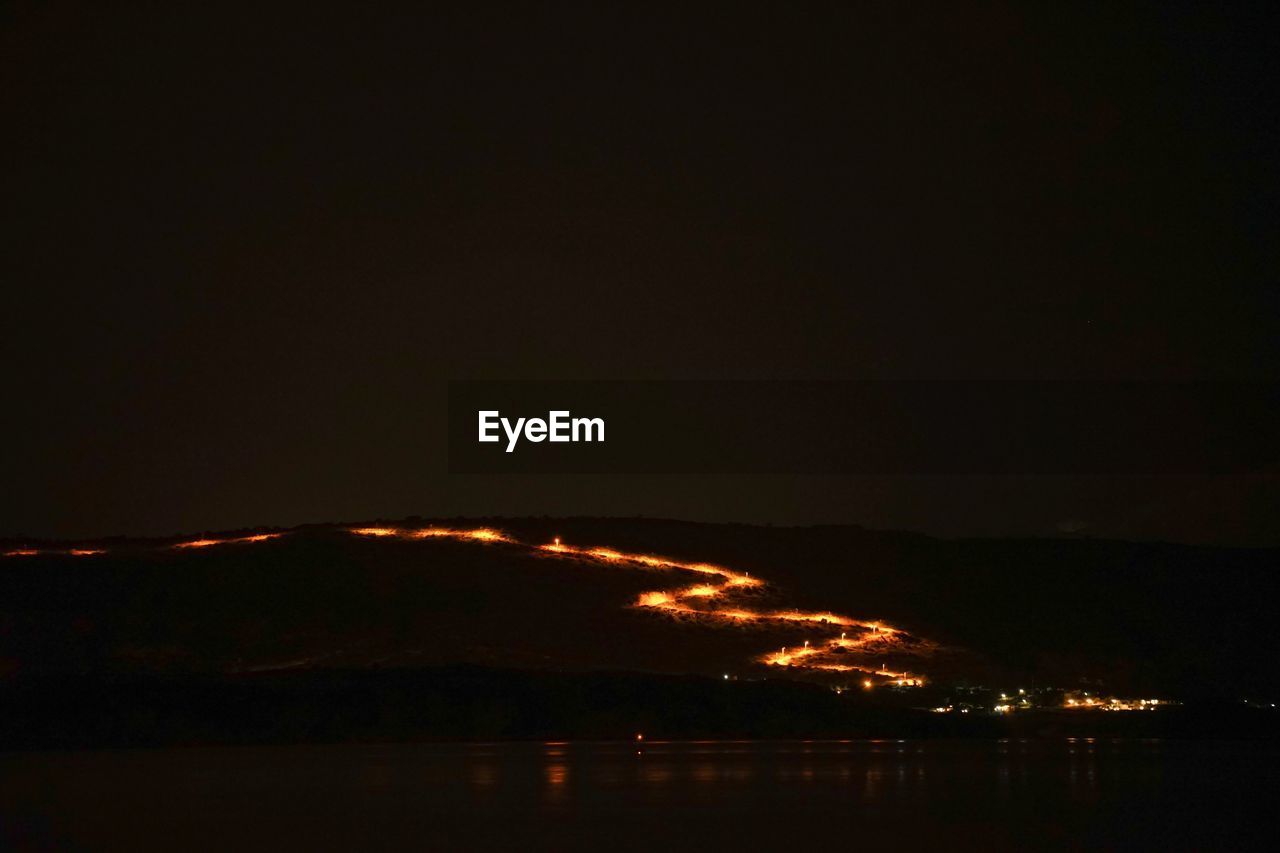 Scenic view of silhouette mountain against sky at night