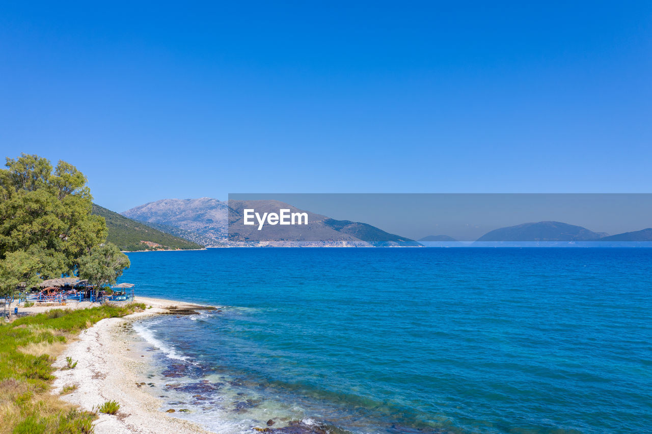 Scenic view of sea against clear blue sky