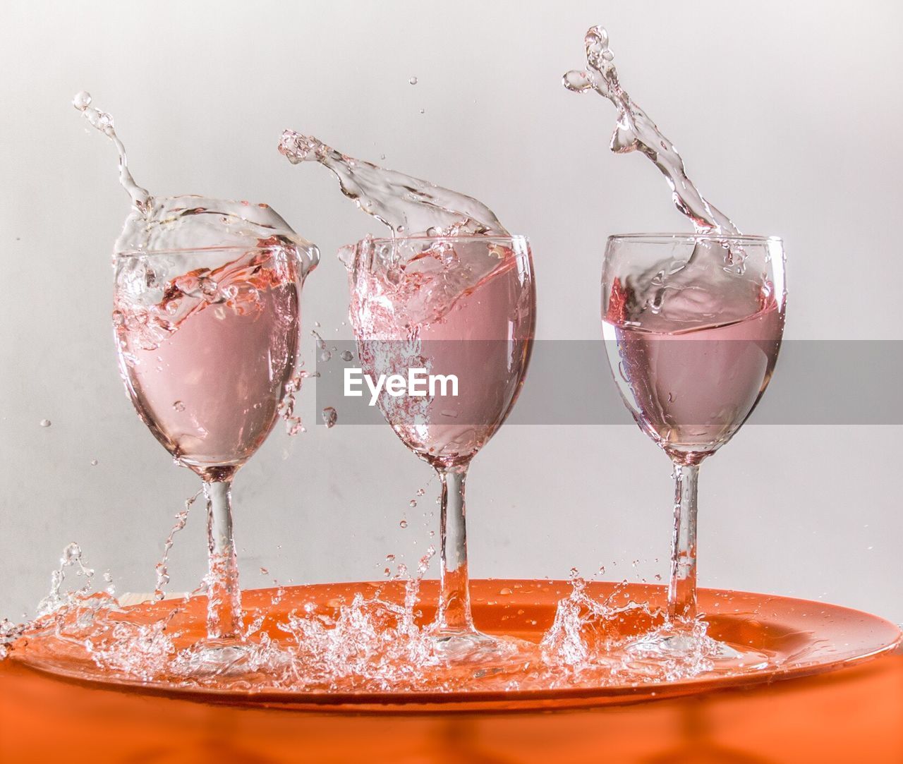 Splash wineglass against white background