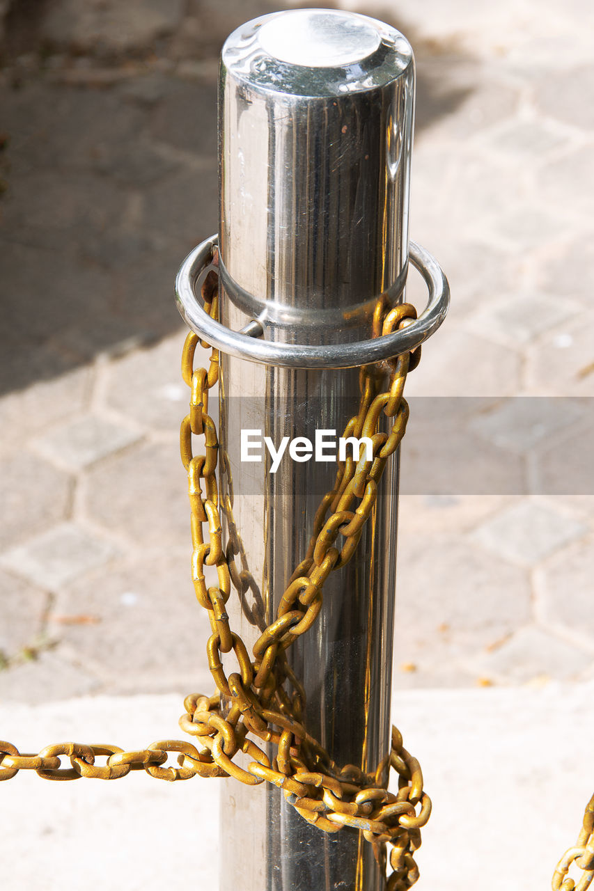 Close-up of metal chain against wall