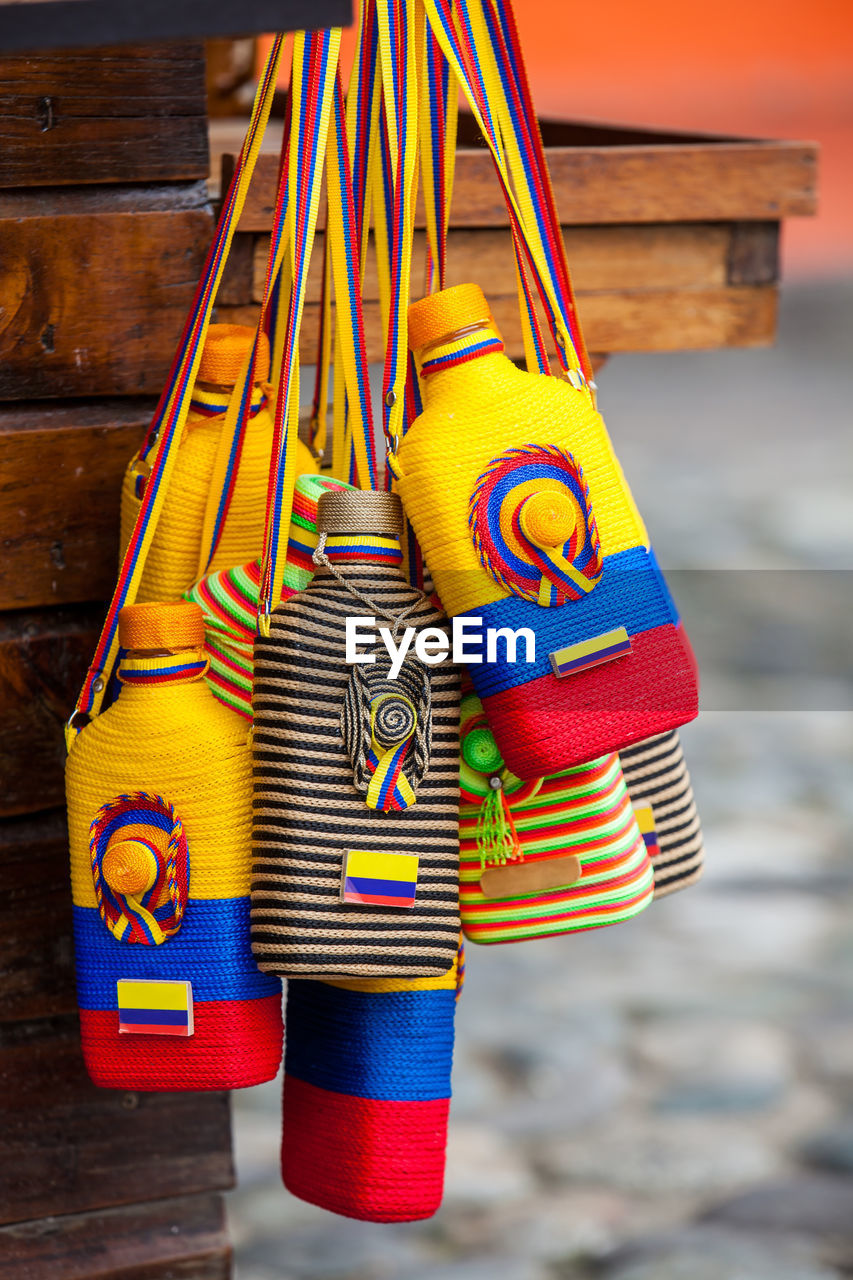 Liquor bottles used for traditional aguardiente decorated with the colors of the colombian flag