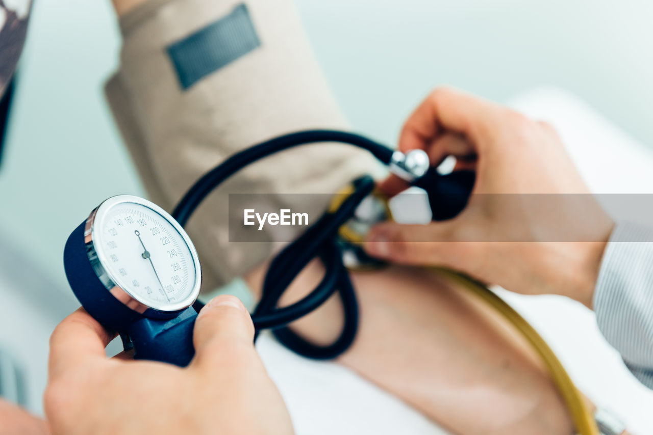 Cropped image of doctor examining patient