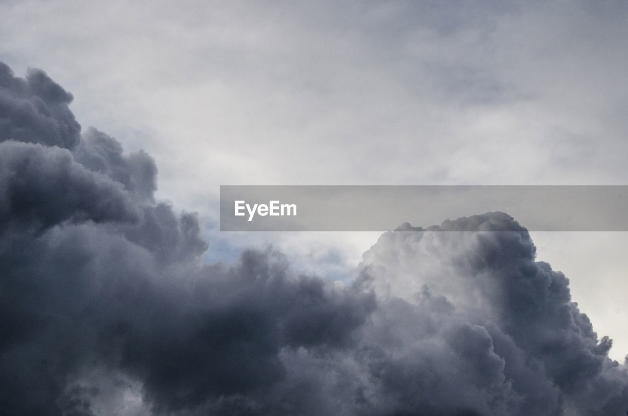 Low angle view of mountain against cloudy sky