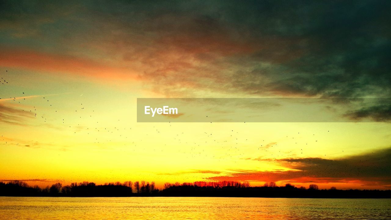 SCENIC VIEW OF SUNSET OVER LAKE