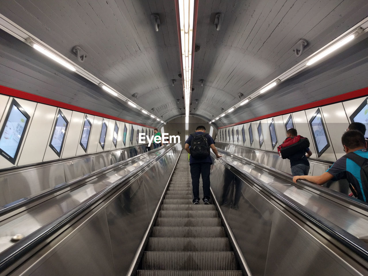 REAR VIEW OF PEOPLE ON SUBWAY STATION