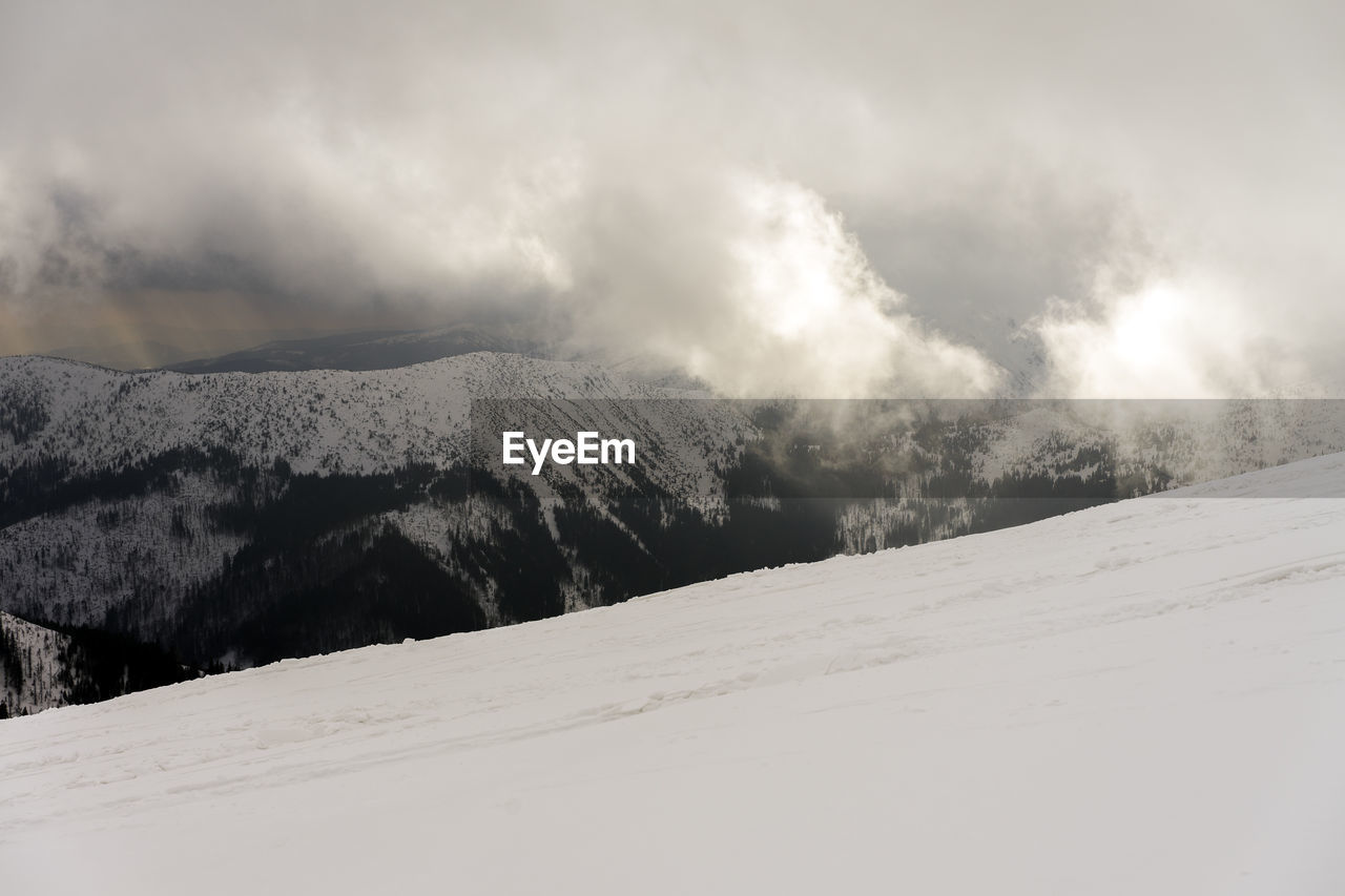 Scenic view of snow covered mountains against sky