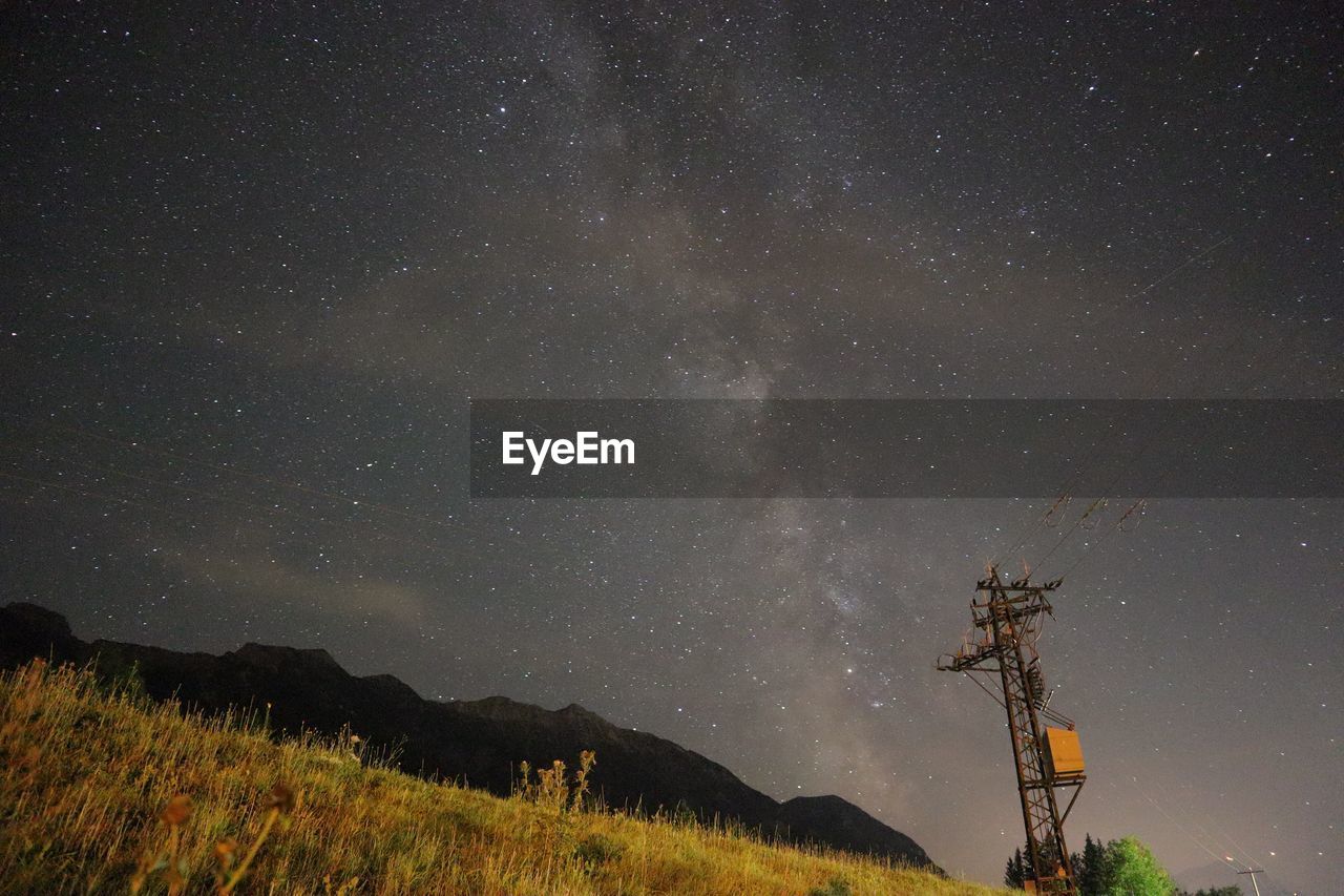 LOW ANGLE VIEW OF STAR FIELD AGAINST SKY