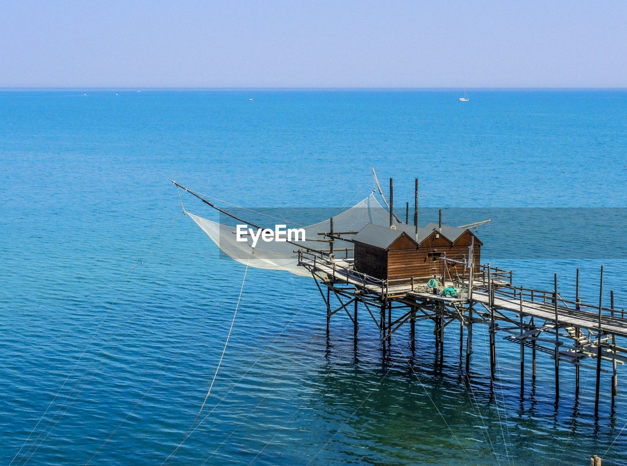 LIFEGUARD HUT ON SEA AGAINST CLEAR SKY