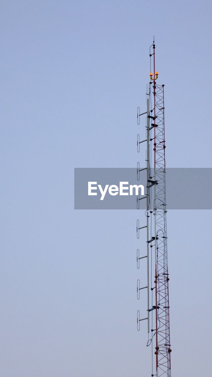 LOW ANGLE VIEW OF TELEPHONE POLE AGAINST CLEAR SKY