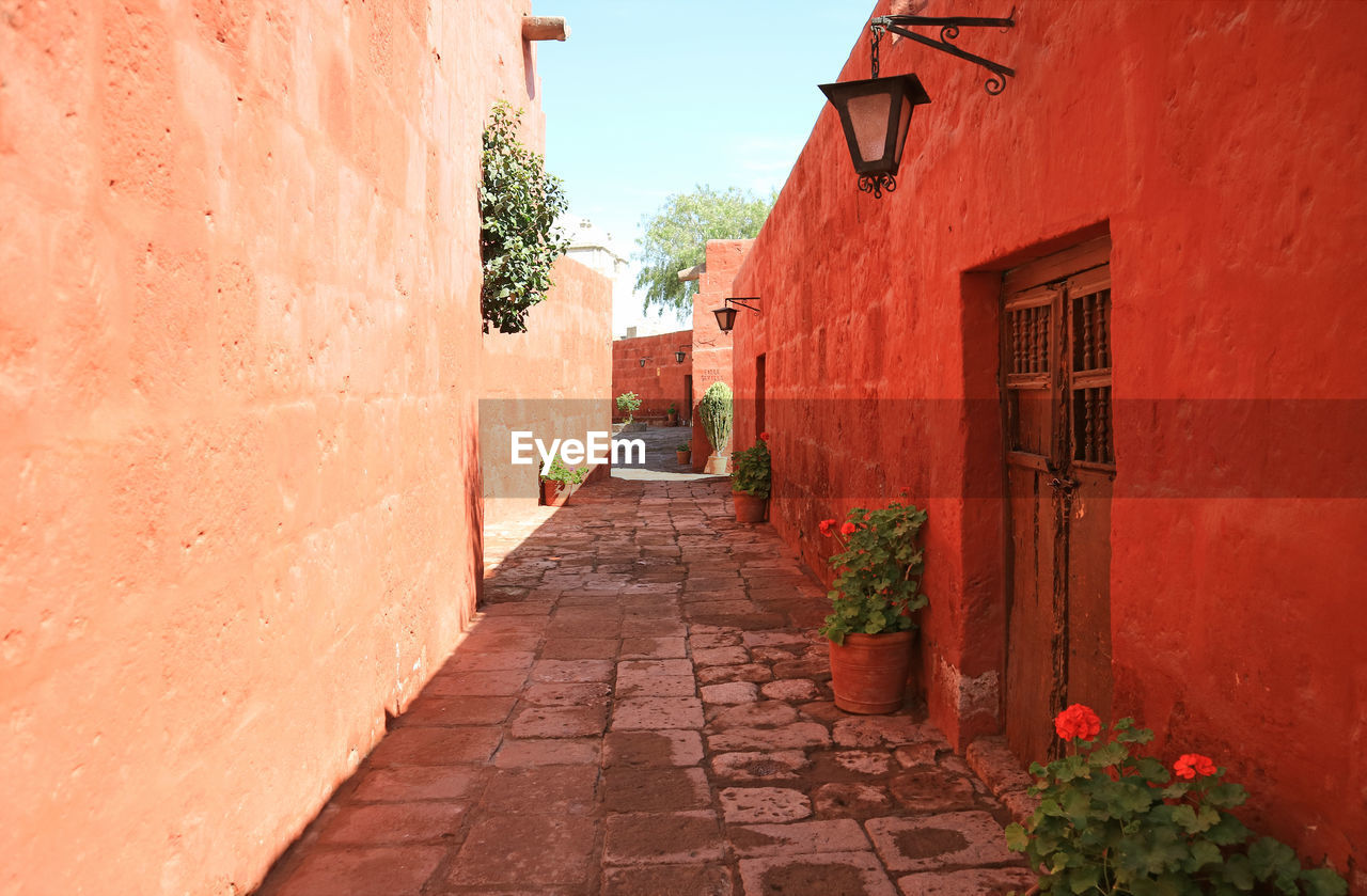 Cobblestone path among red and orange buildings in the monastery of santa catalina, arequipa, peru