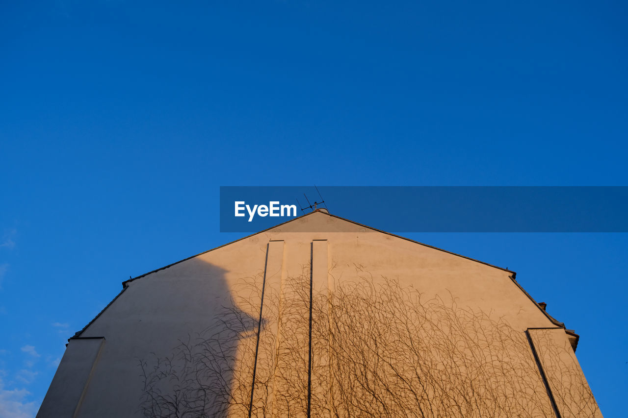 Low angle view of building against blue sky