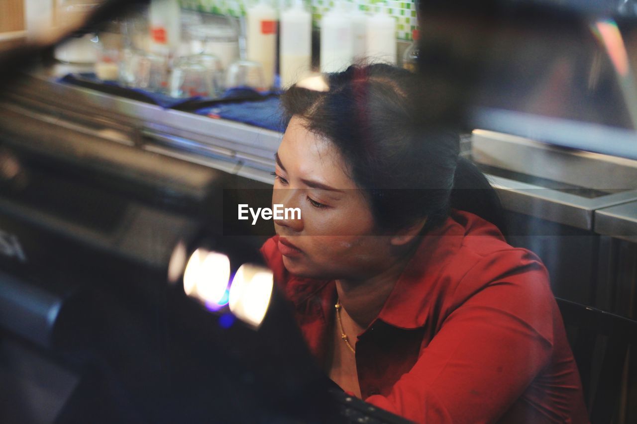 Serious woman sitting in restaurant