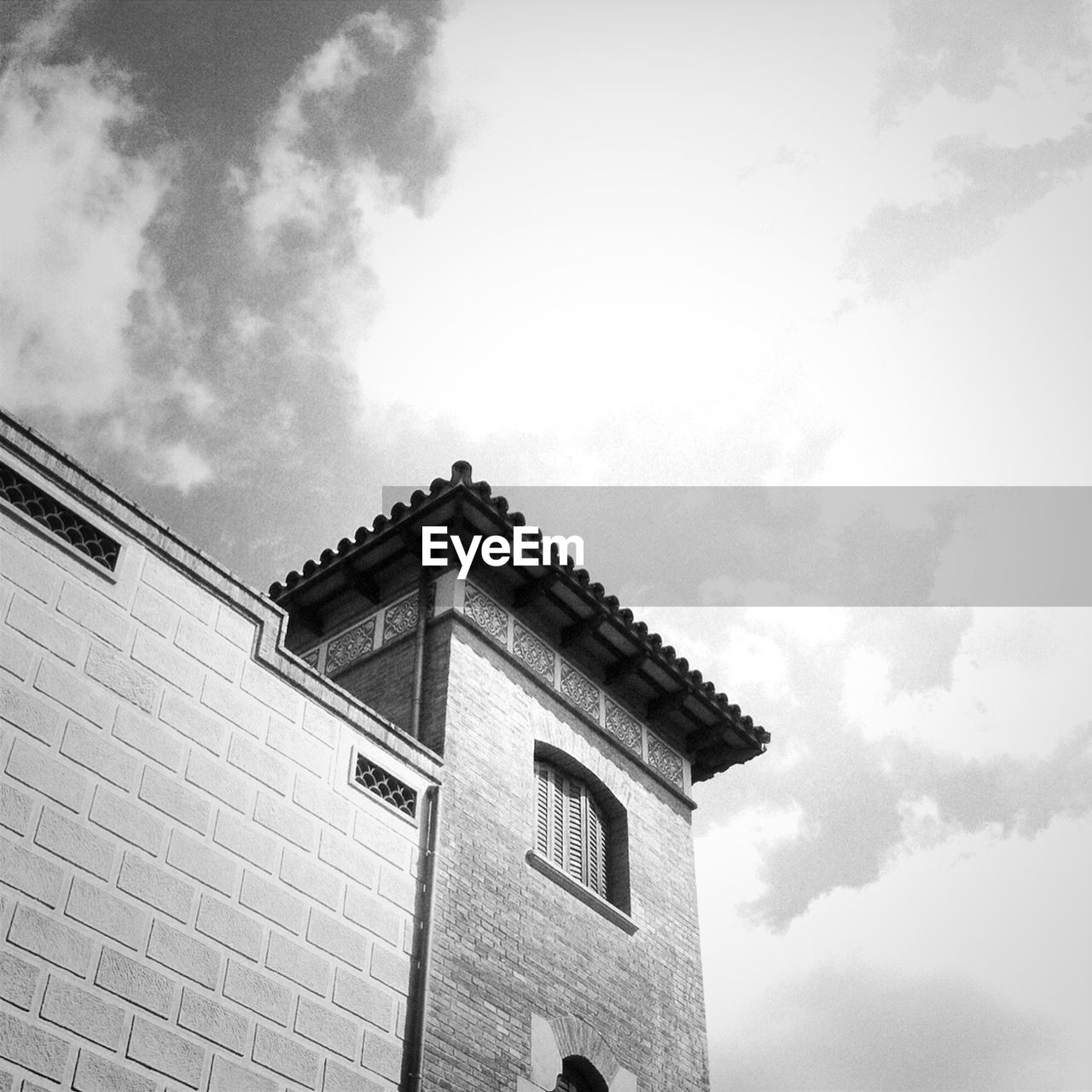 Low angle view of built structure against cloudy sky