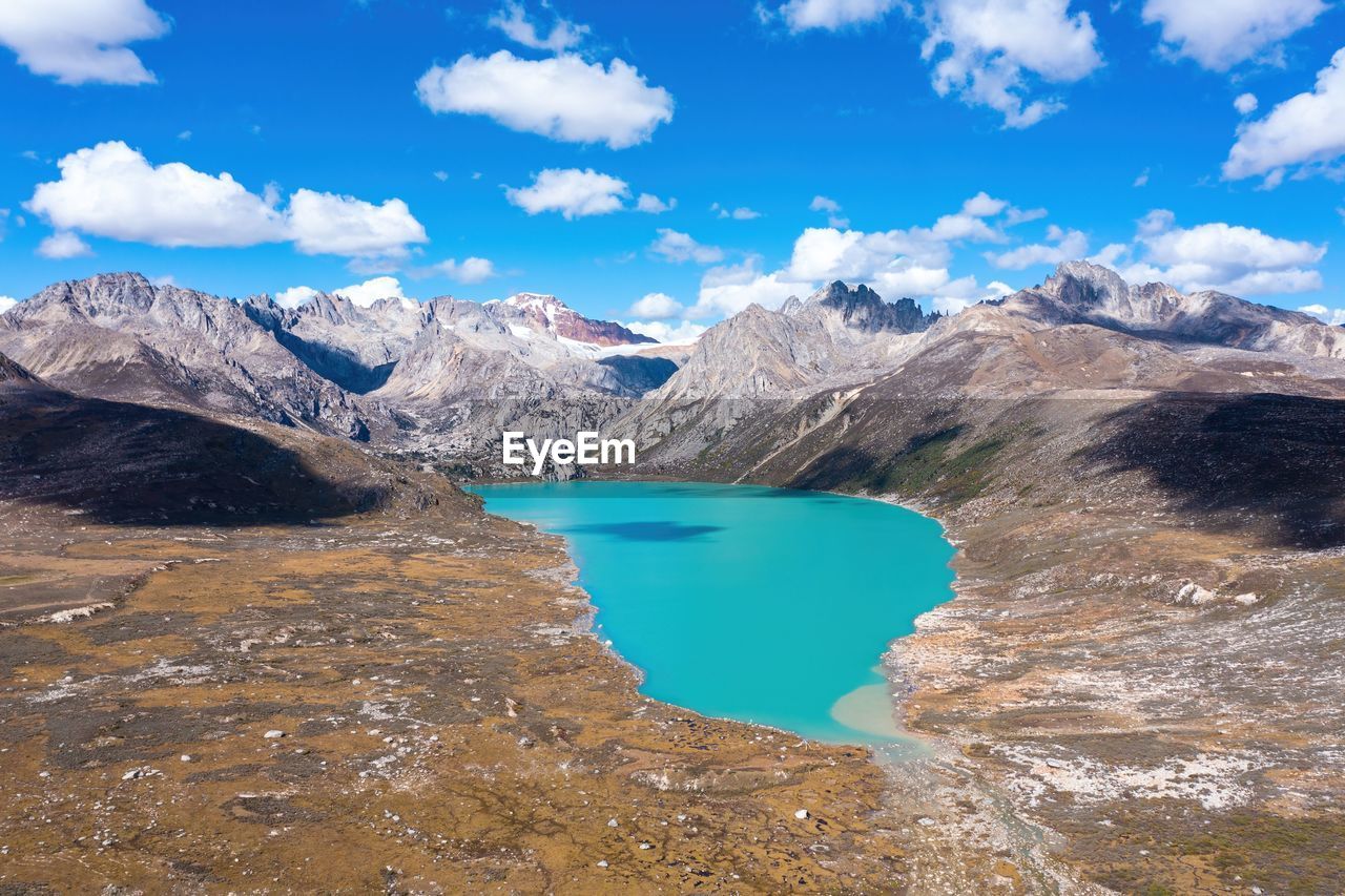 mountain, environment, landscape, scenics - nature, water, sky, beauty in nature, nature, cloud, mountain range, lake, travel destinations, blue, travel, land, snow, cold temperature, glacier, no people, wilderness, tourism, winter, outdoors, social issues, crater lake, mountain peak, ice, non-urban scene, day, tranquility, rock, moraine, turquoise colored, activity, tranquil scene, snowcapped mountain, glacial landform, lagoon, extreme terrain, environmental conservation, glacial lake, plateau, leisure activity