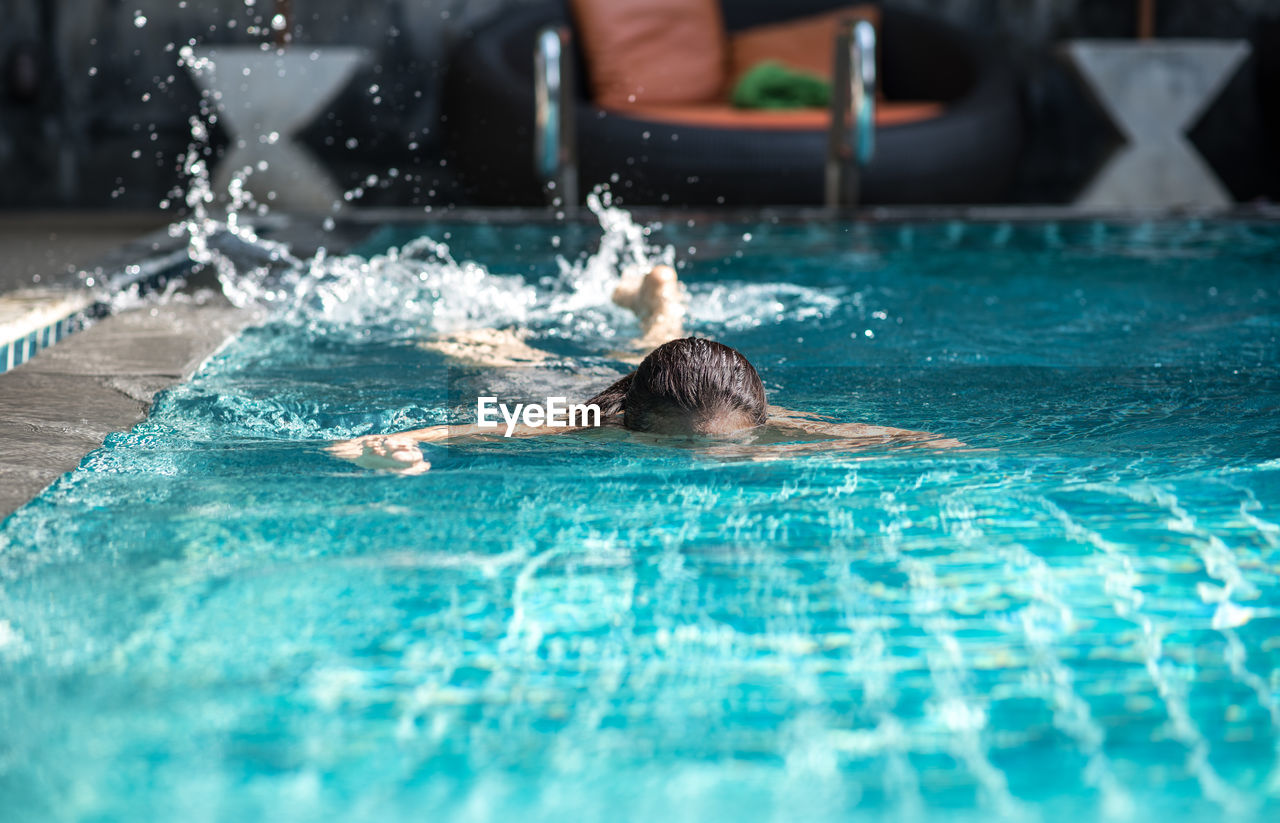 Mature woman swimming in pool