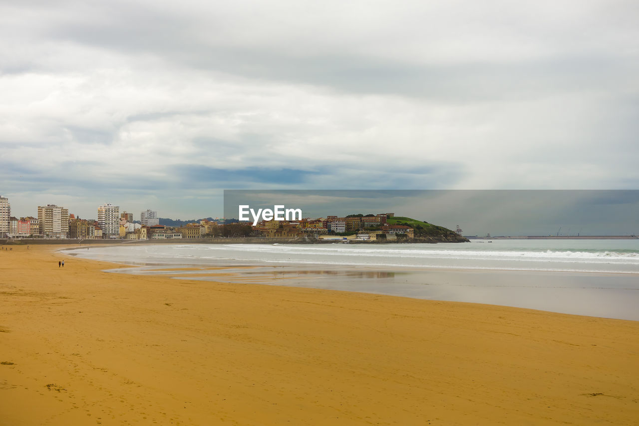 Scenic view of beach against sky in city