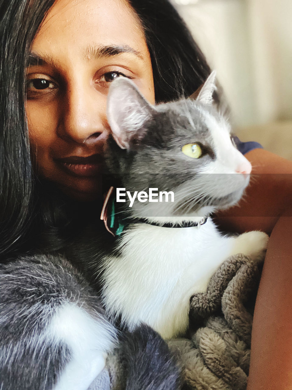 Close-up portrait of woman carrying cat