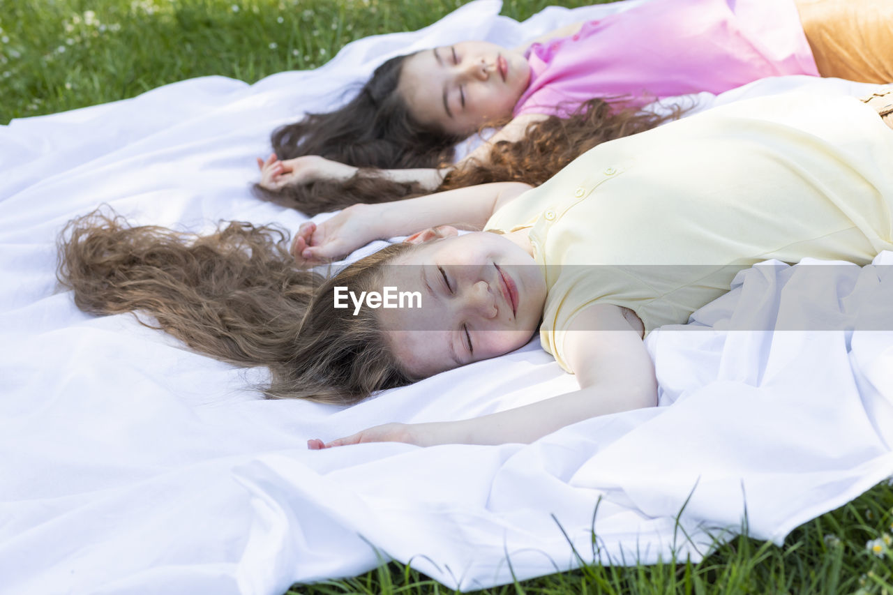 portrait of young woman lying on grass
