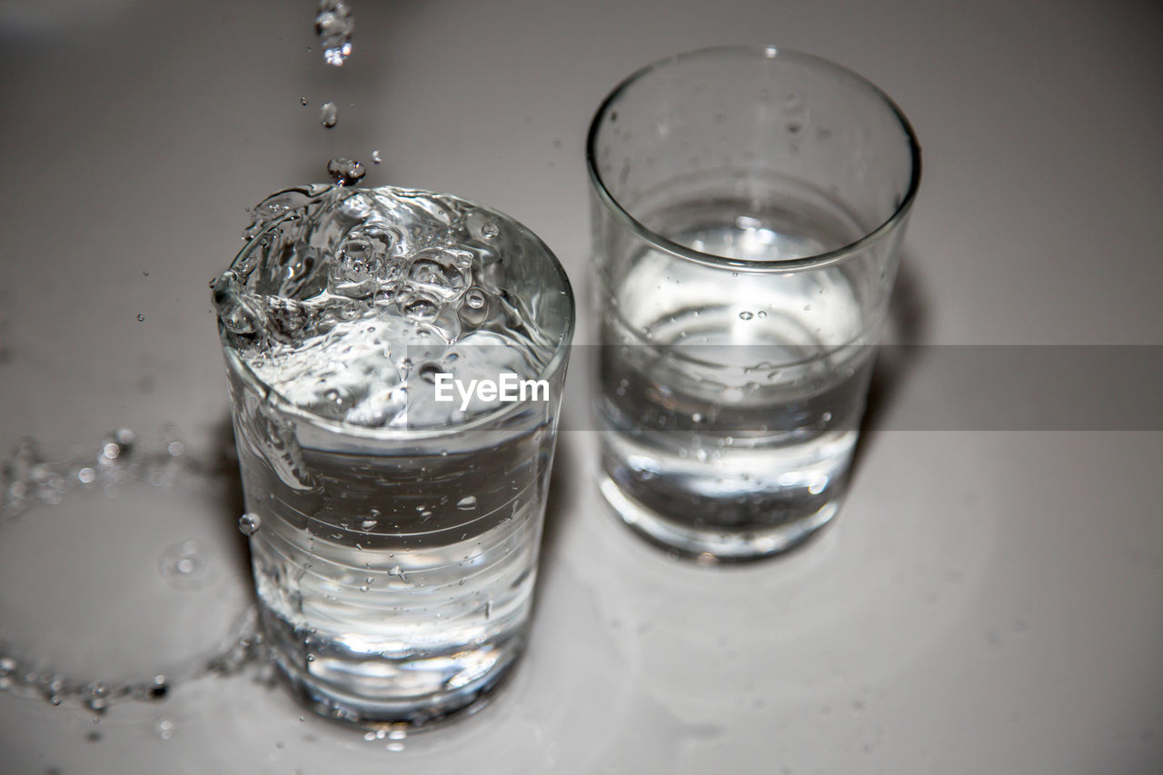 High angle view of water dripping in glass