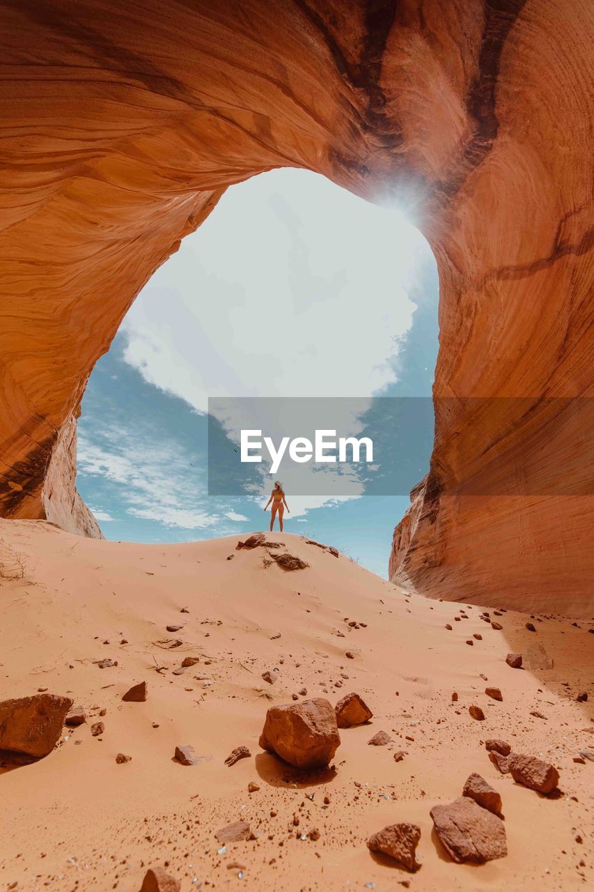 Woman standing against rock formations