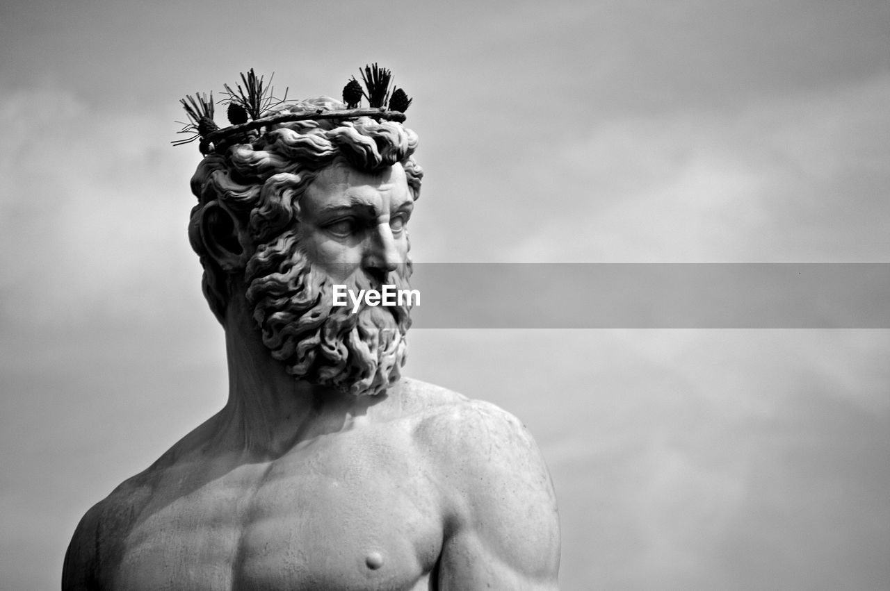 Low angle view of statue against cloudy sky