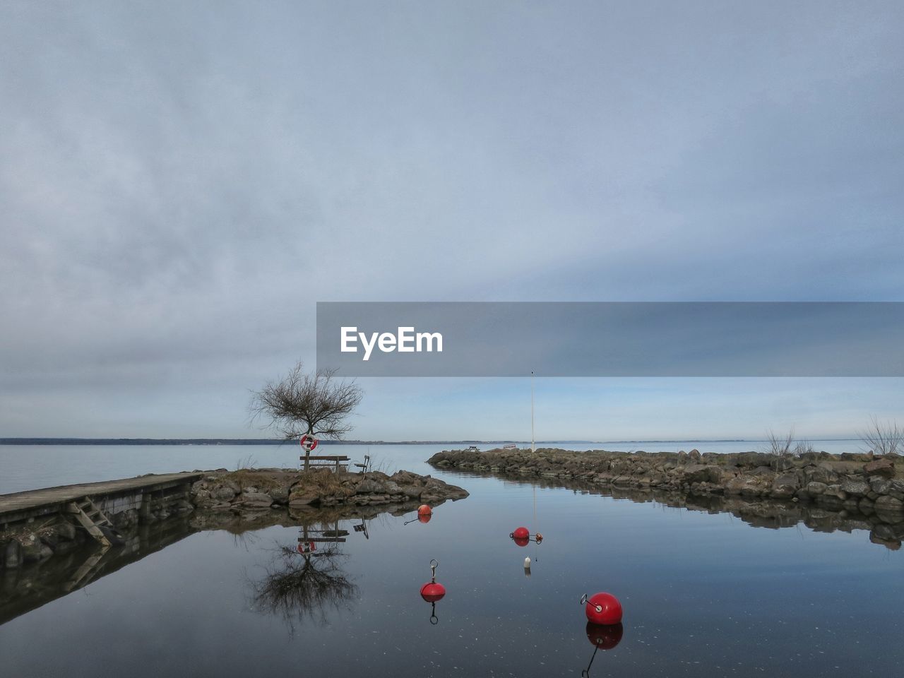 View of buoy in river against sky