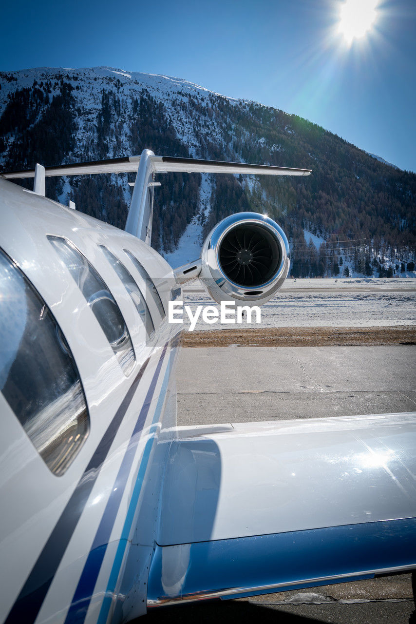 transportation, sky, blue, nature, vehicle, winter, mode of transportation, snow, cold temperature, aviation, airplane, mountain, travel, aircraft, environment, no people, sun, reflection, sunlight, scenics - nature, outdoors, air vehicle