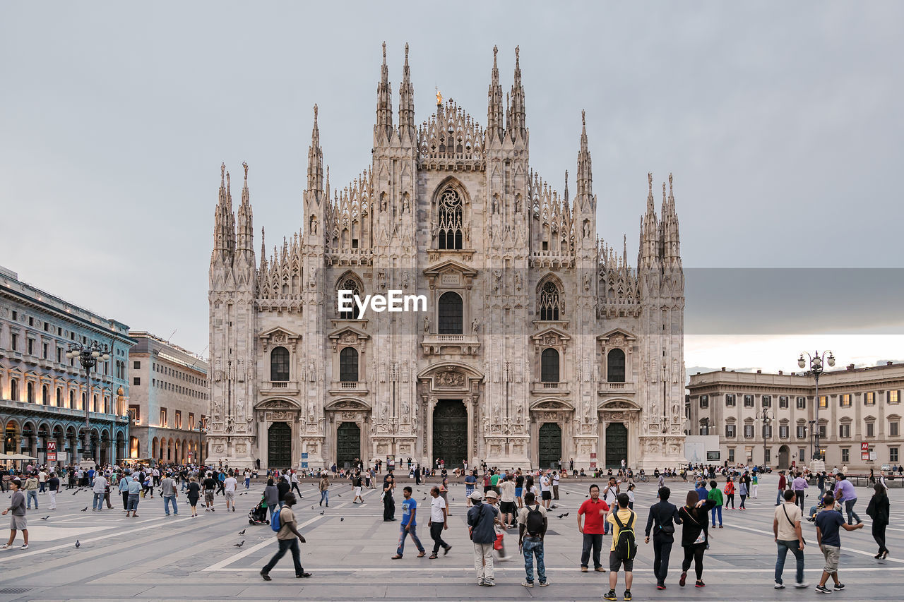 Crowd at milan cathedral against sky