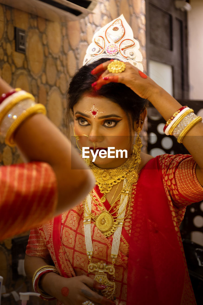 Portrait of young woman getting ready for her wedding