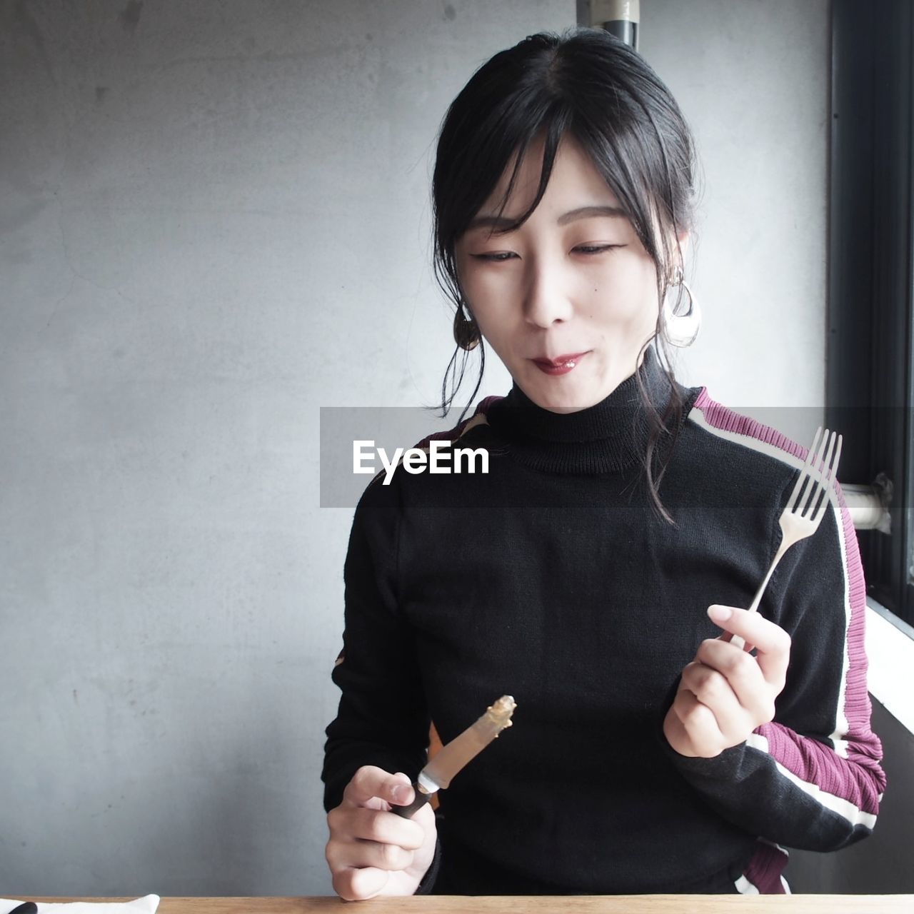 Woman eating food in restaurant