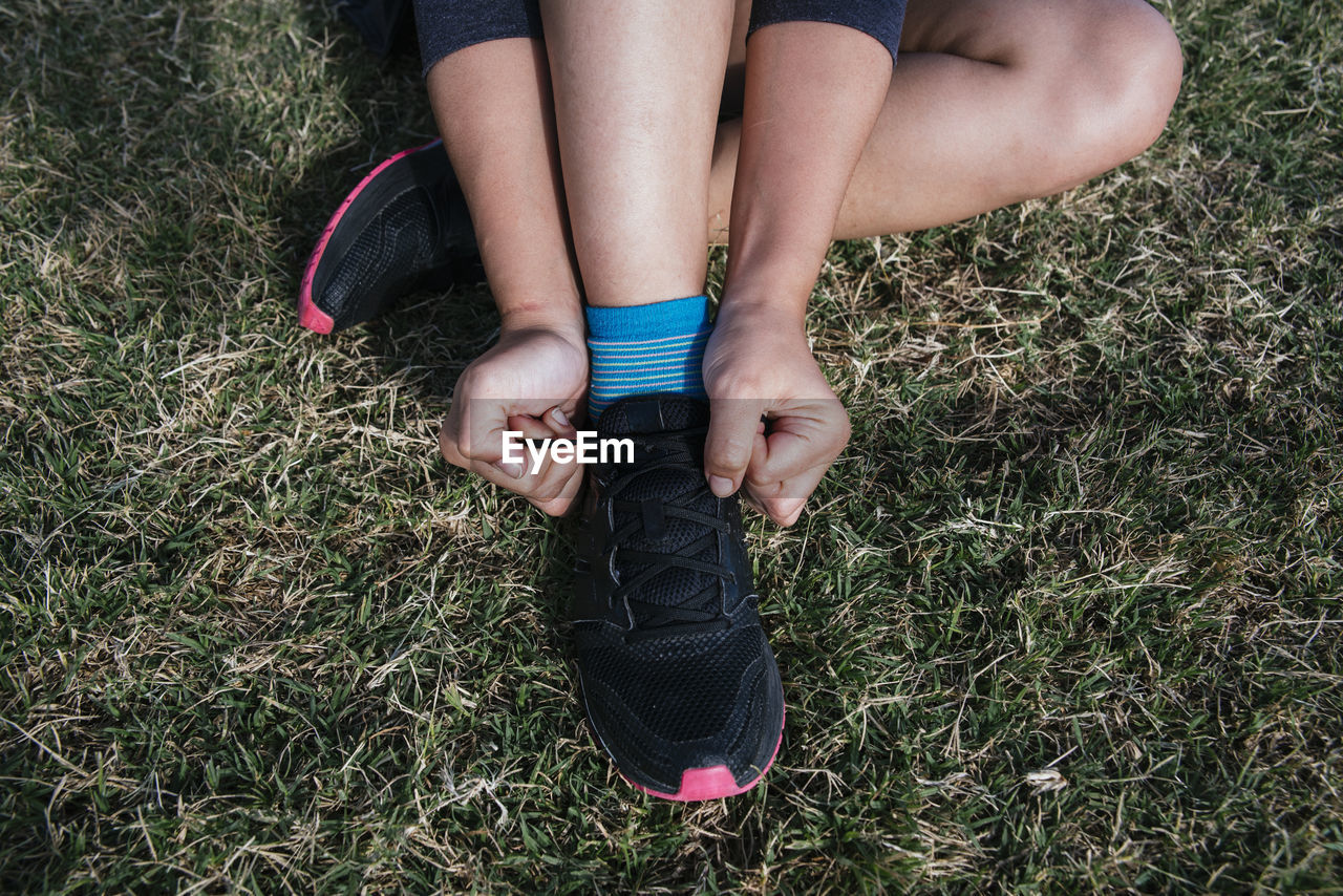 Tying her shoelaces to run