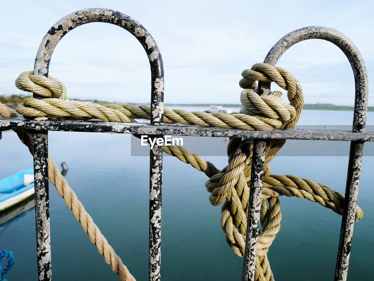 Close-up of rope tied to sea against sky