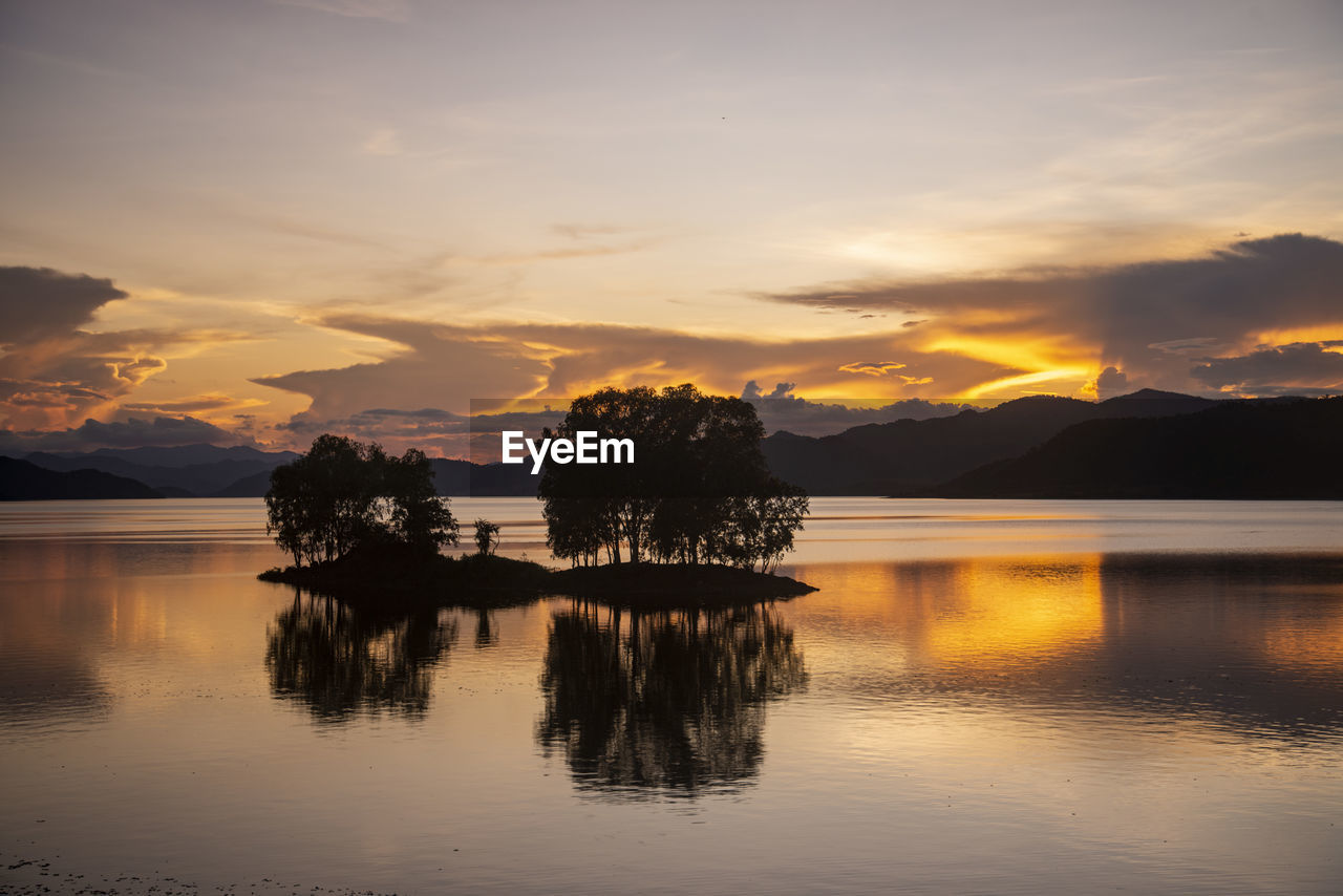 scenic view of lake against orange sky